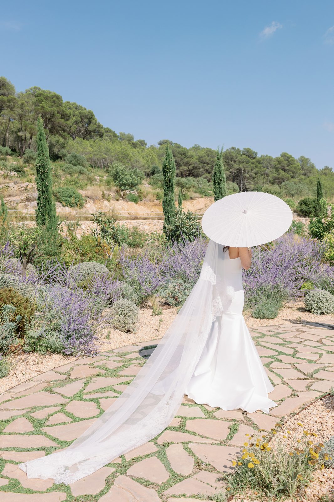 Janice — bride with white paper parasol in the lavender garden
