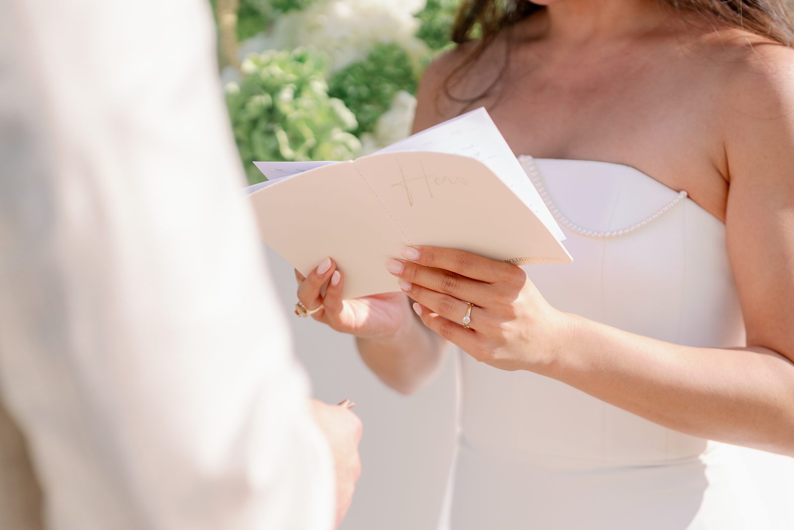 Wedding vows booklet 'Hers' and engagement ring detail