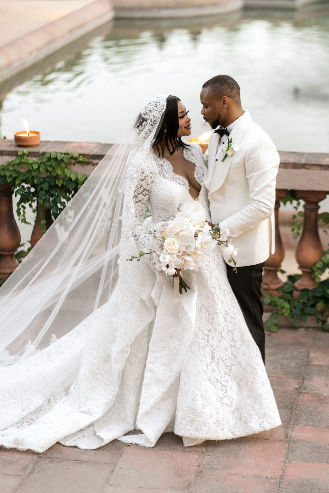 Peju & Sola — couple by the fountain at dusk